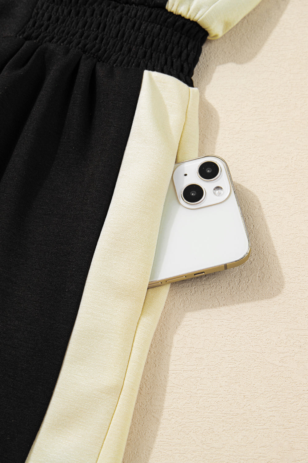 Phone case on a black and beige fabric background