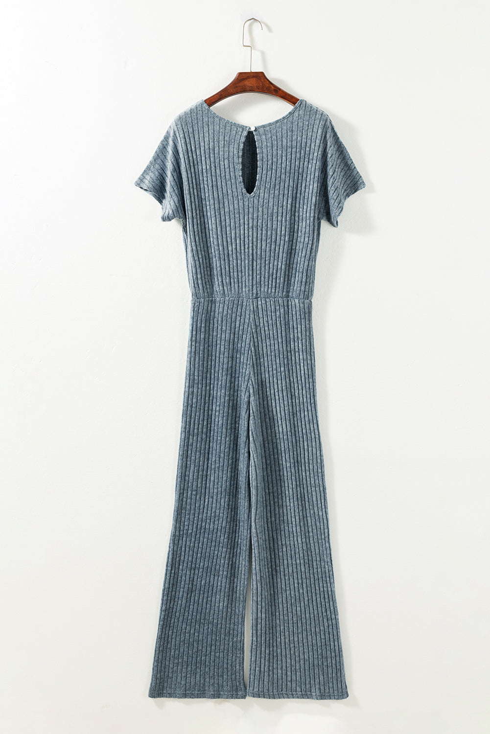 Blue striped jumpsuit on a hanger against a white background