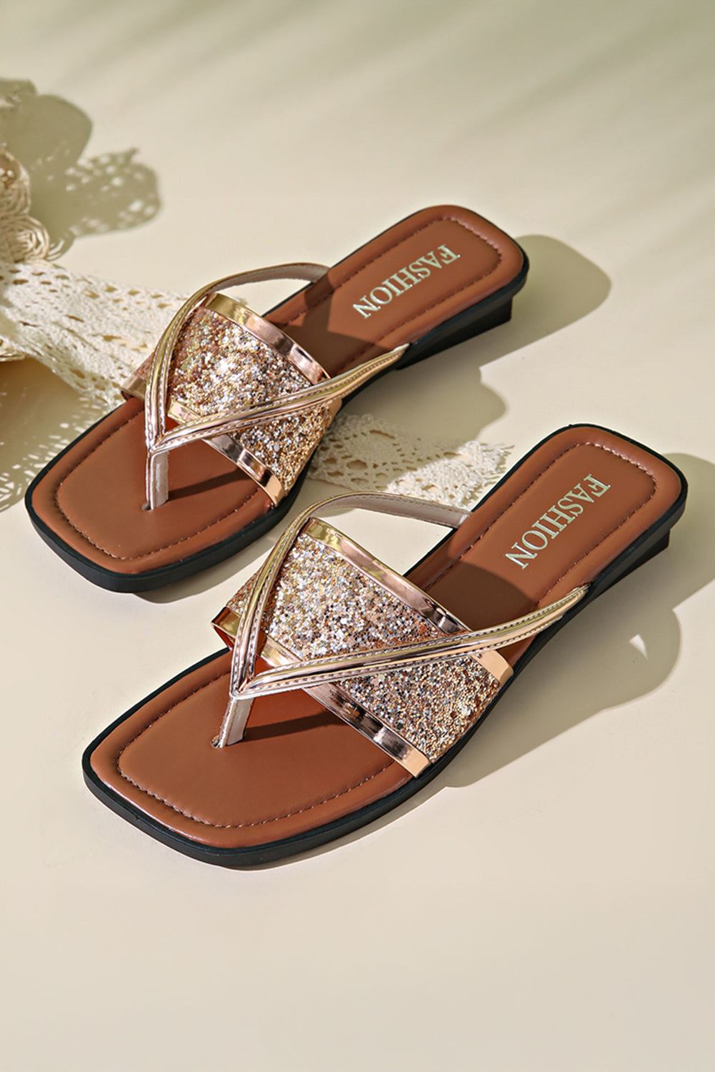 Pair of glittery sandals with brown soles 