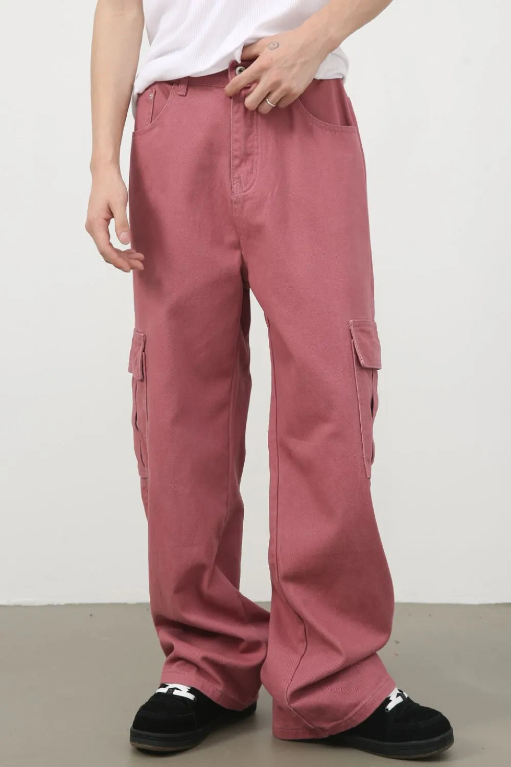 Male model wearing dusty pink Mid Rise Jeans with Cargo Pockets front view