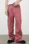 Male model wearing dusty pink Mid Rise Jeans with Cargo Pockets front view
