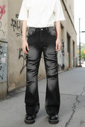 Male model wearing a pair of black acid washed Bootcut Jeans front view