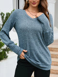 Woman wearing a blue knitted sweater outdoors