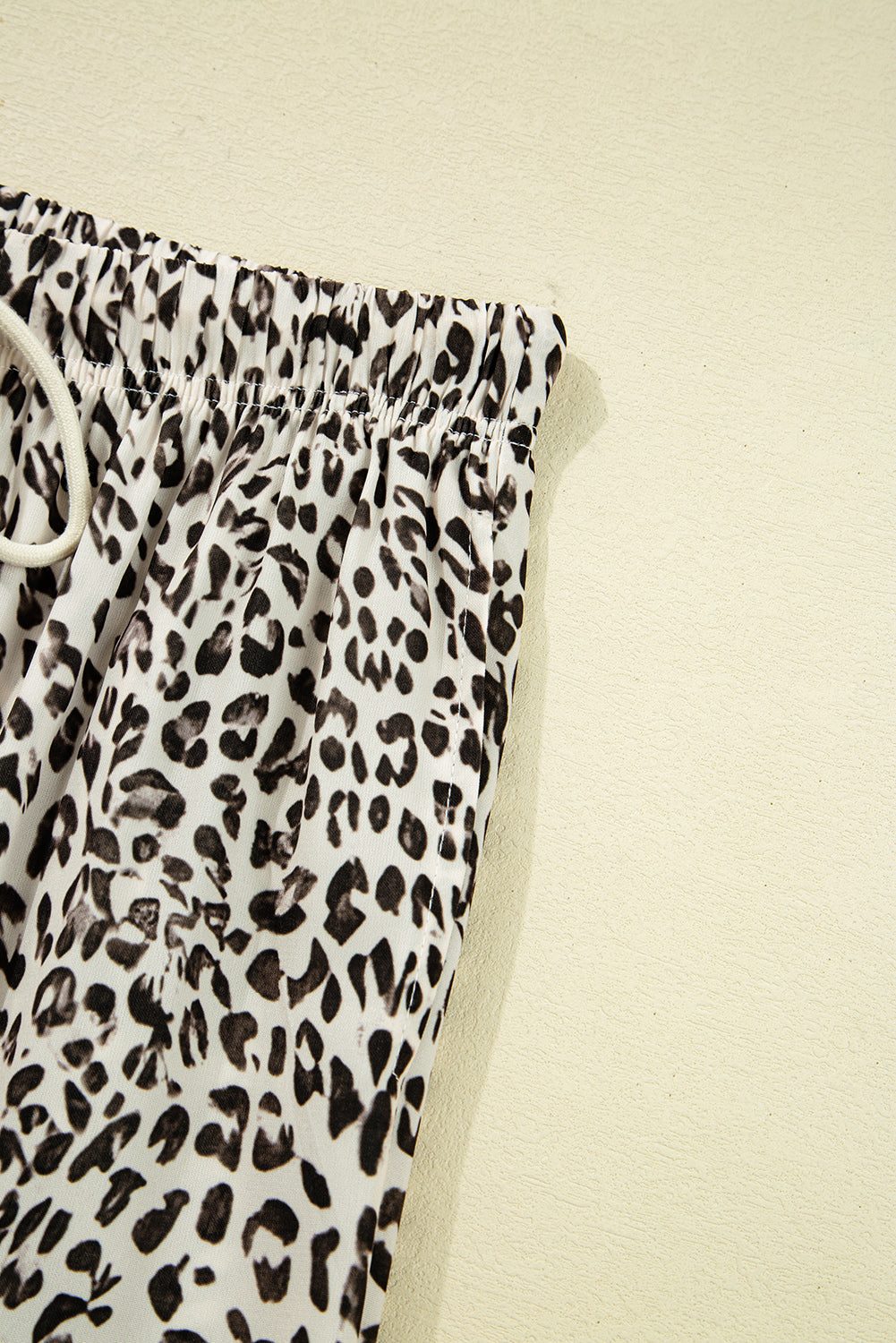 Leopard print pants on a beige background