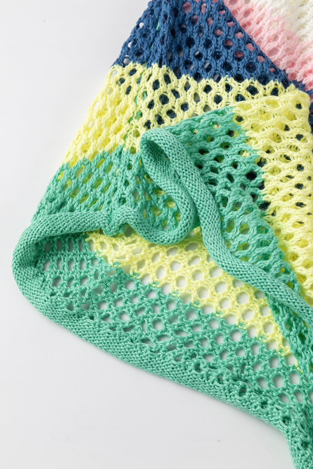 Colorful knitted blanket with a geometric pattern on a white background