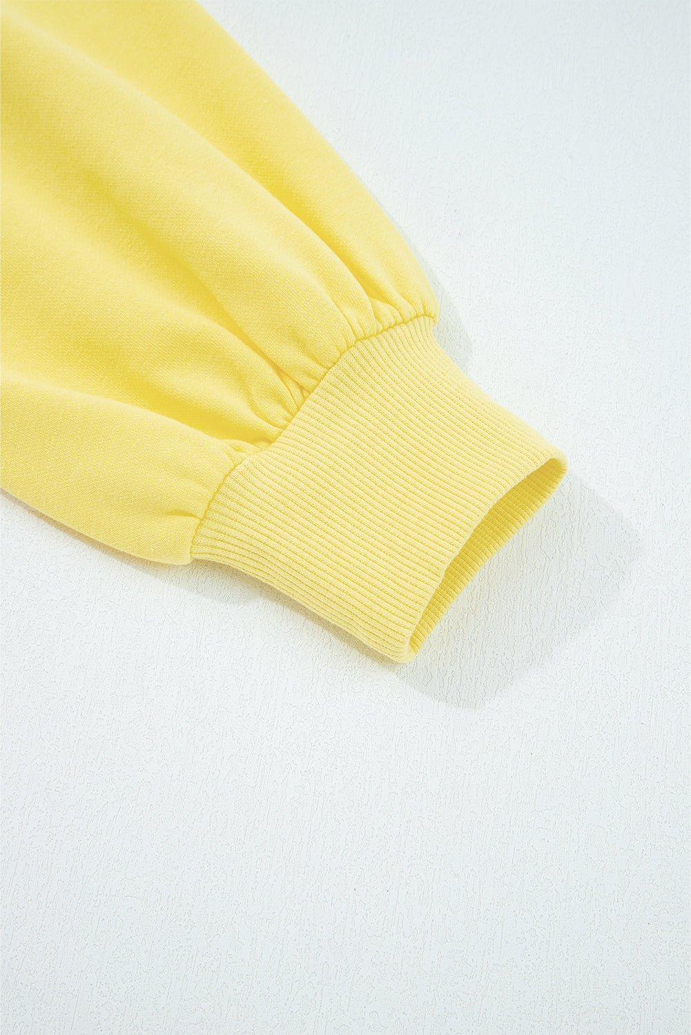 Close-up of a yellow fabric edge on a white background