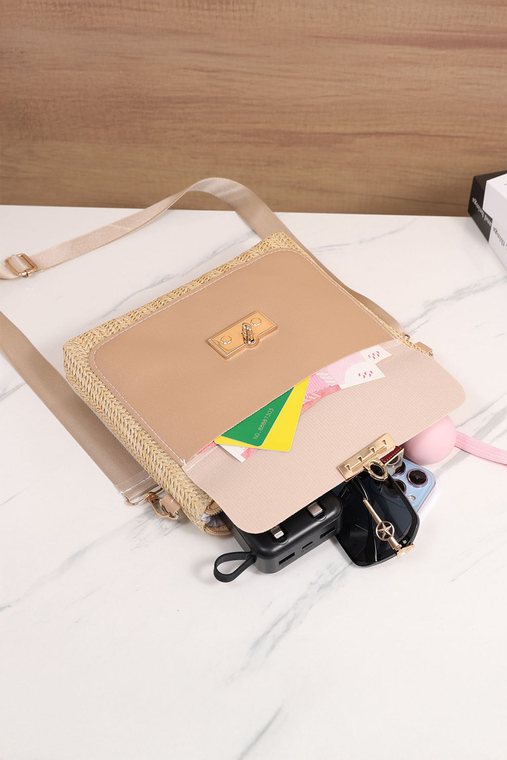 Beige handbag with floral pattern on a white surface