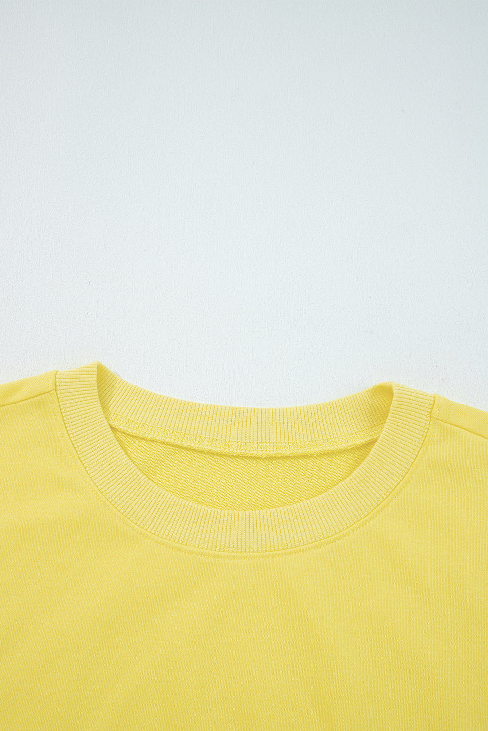 Close-up of a yellow garment on a light gray background