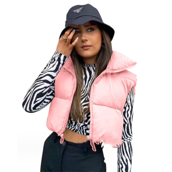 Person wearing a pink puffer vest over a zebra print shirt with a navy bucket hat.