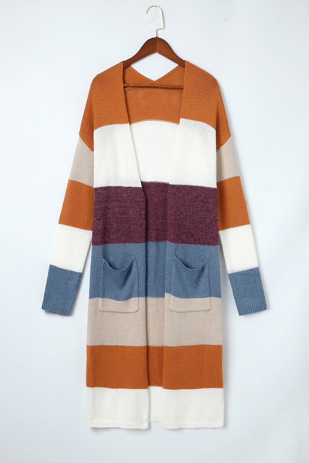 Color-blocked cardigan on a hanger against a white background