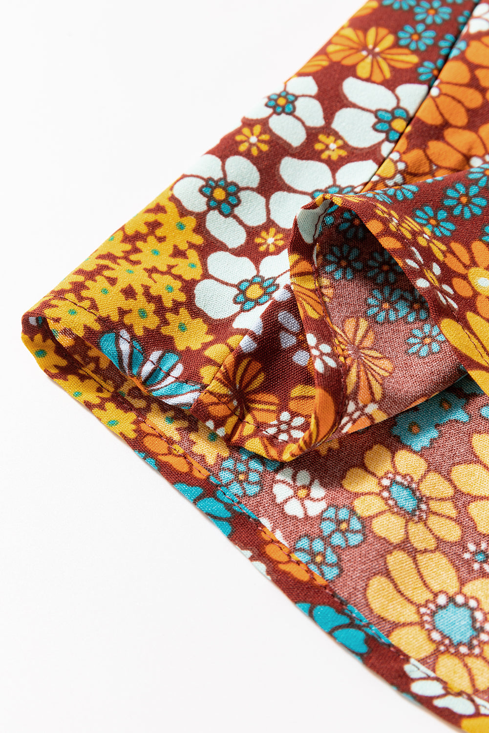 Close-up of colorful floral fabric with a brown background