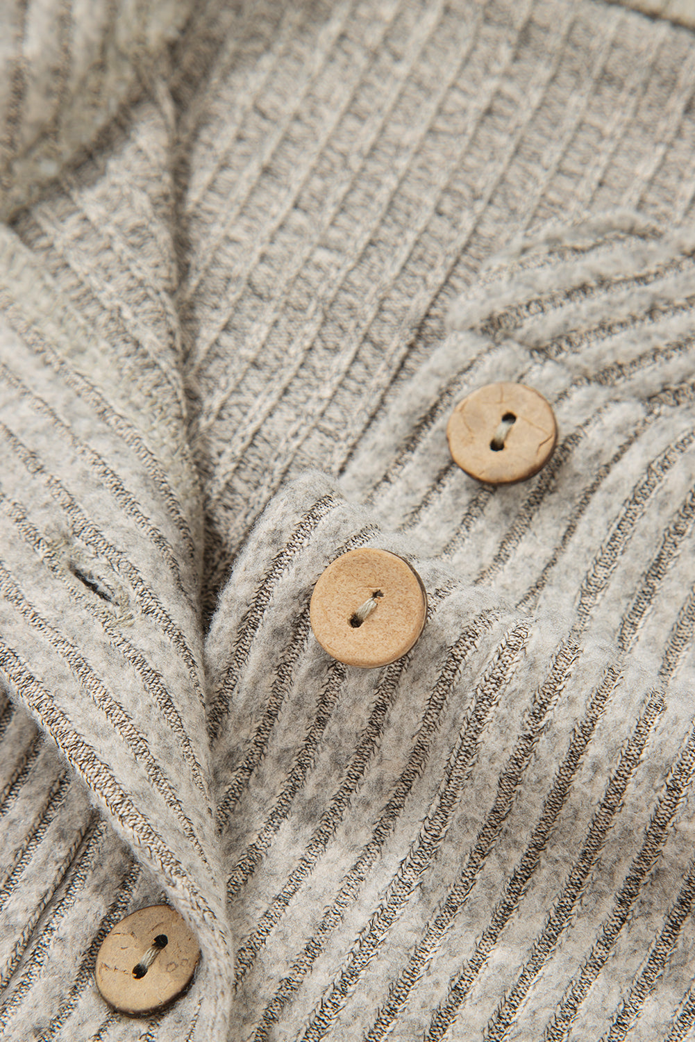 Close-up of a textured fabric with wooden buttons