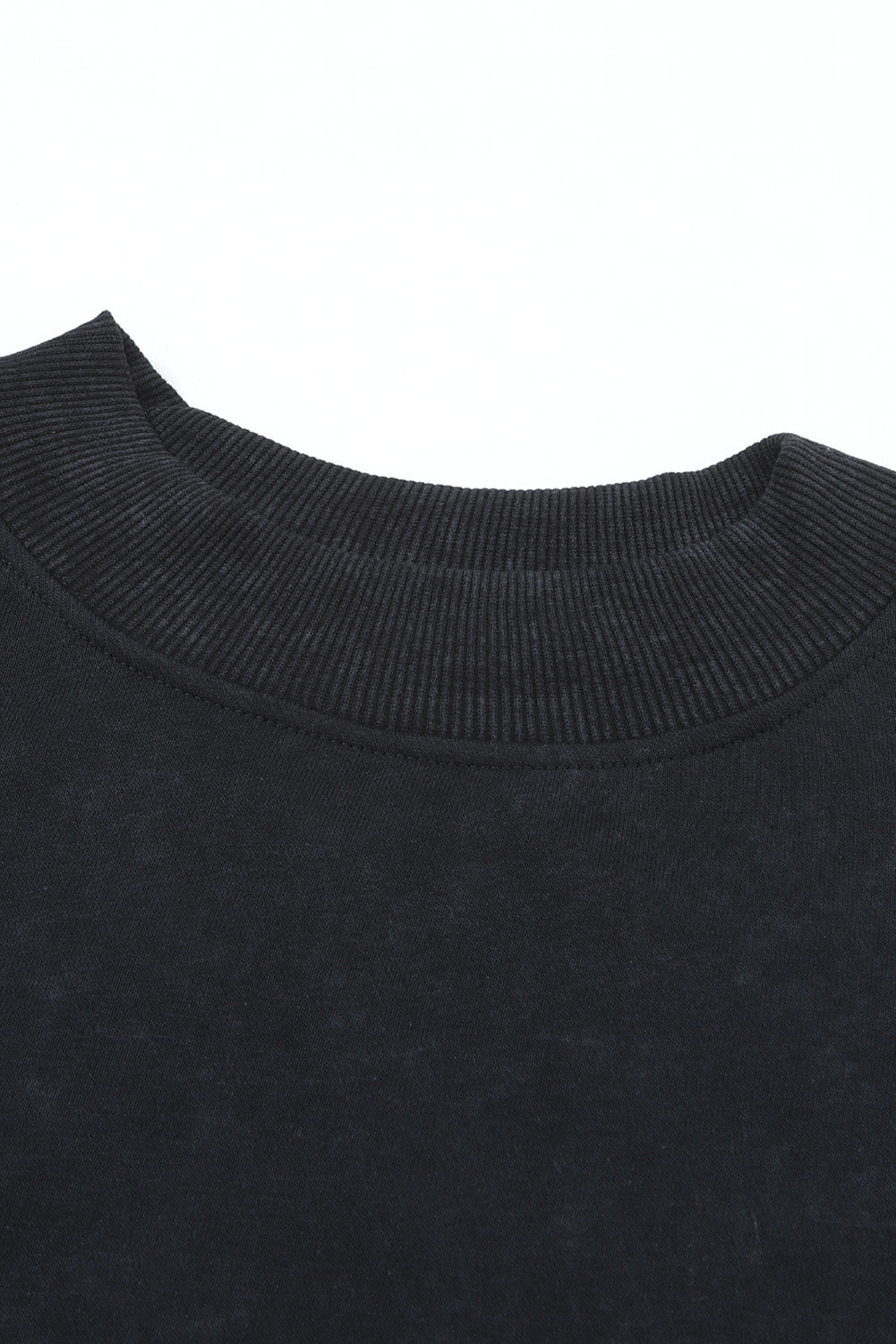 Close-up of a black sweater collar on a white background