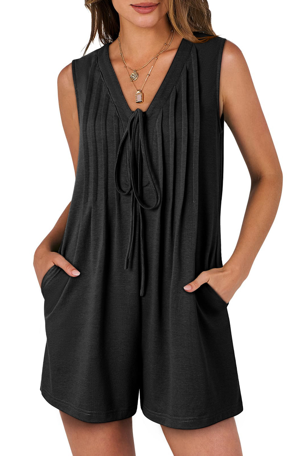 Black sleeveless dress with a tie detail on a white background