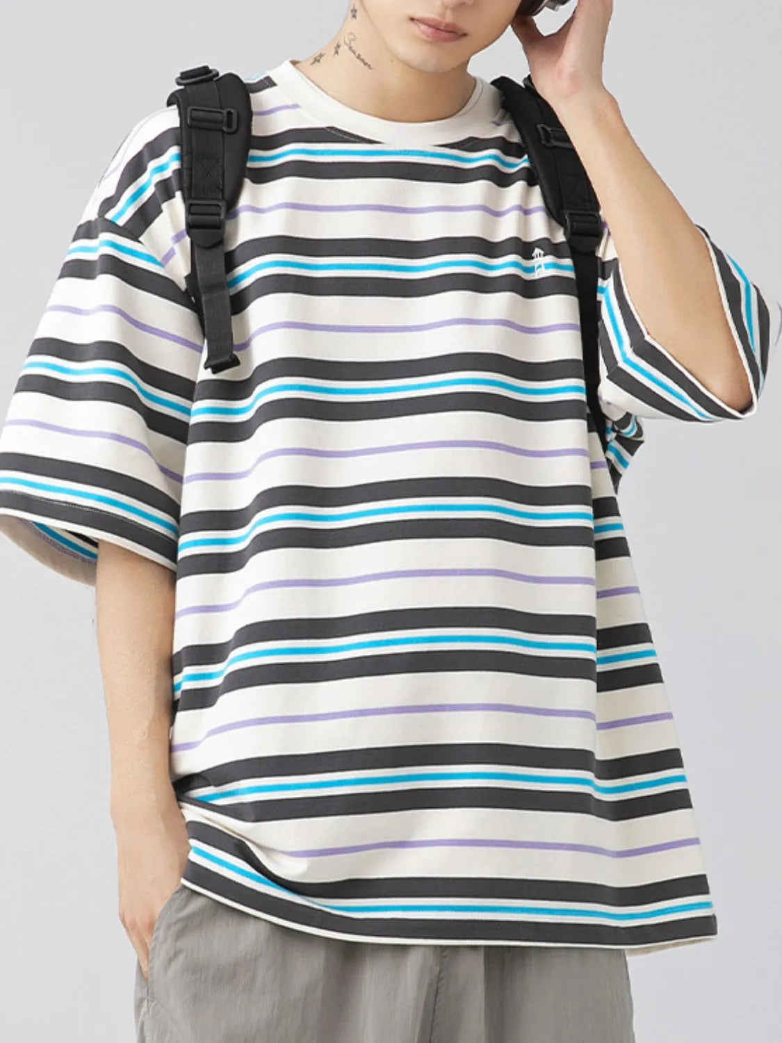 Male model wearing a light blue urban short sleeve stripe t-shirt