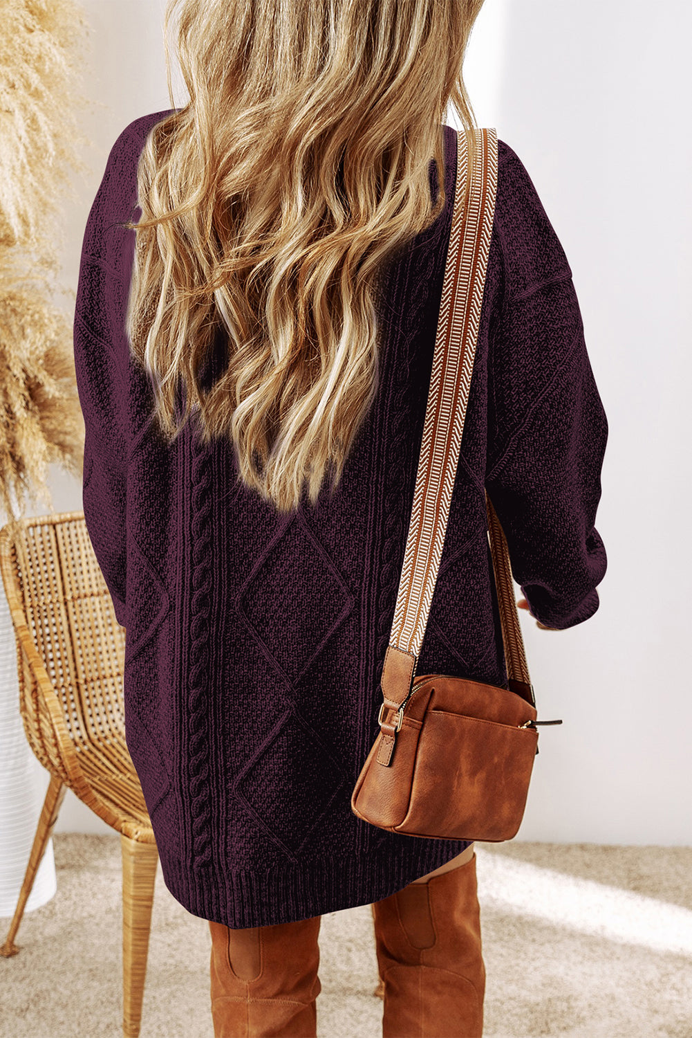 Person wearing a dark purple knitted sweater dress back view