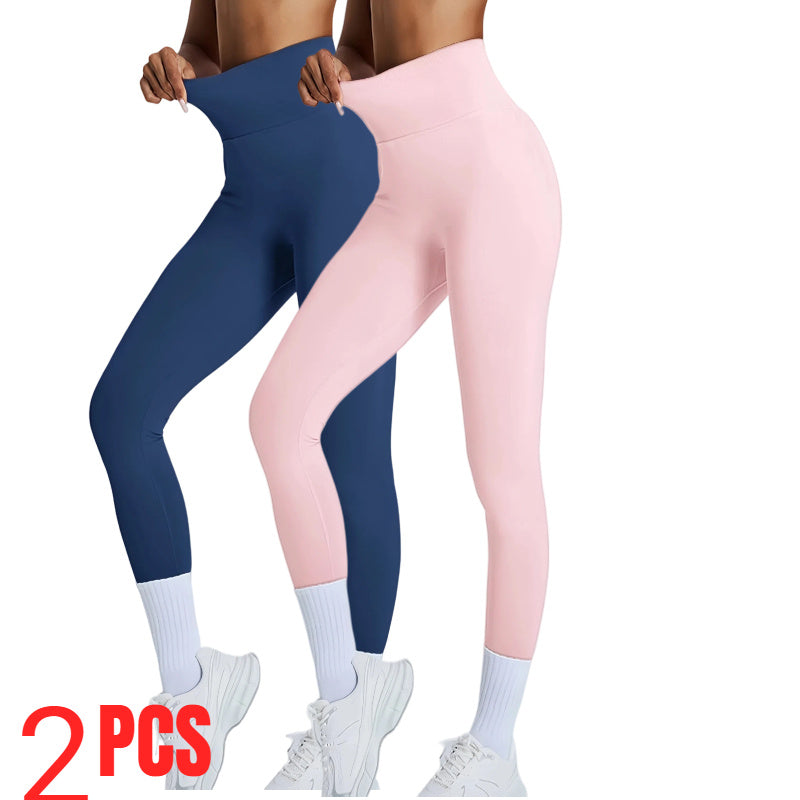 Two pairs of leggings, one navy and one pink, worn by a person on a white background.