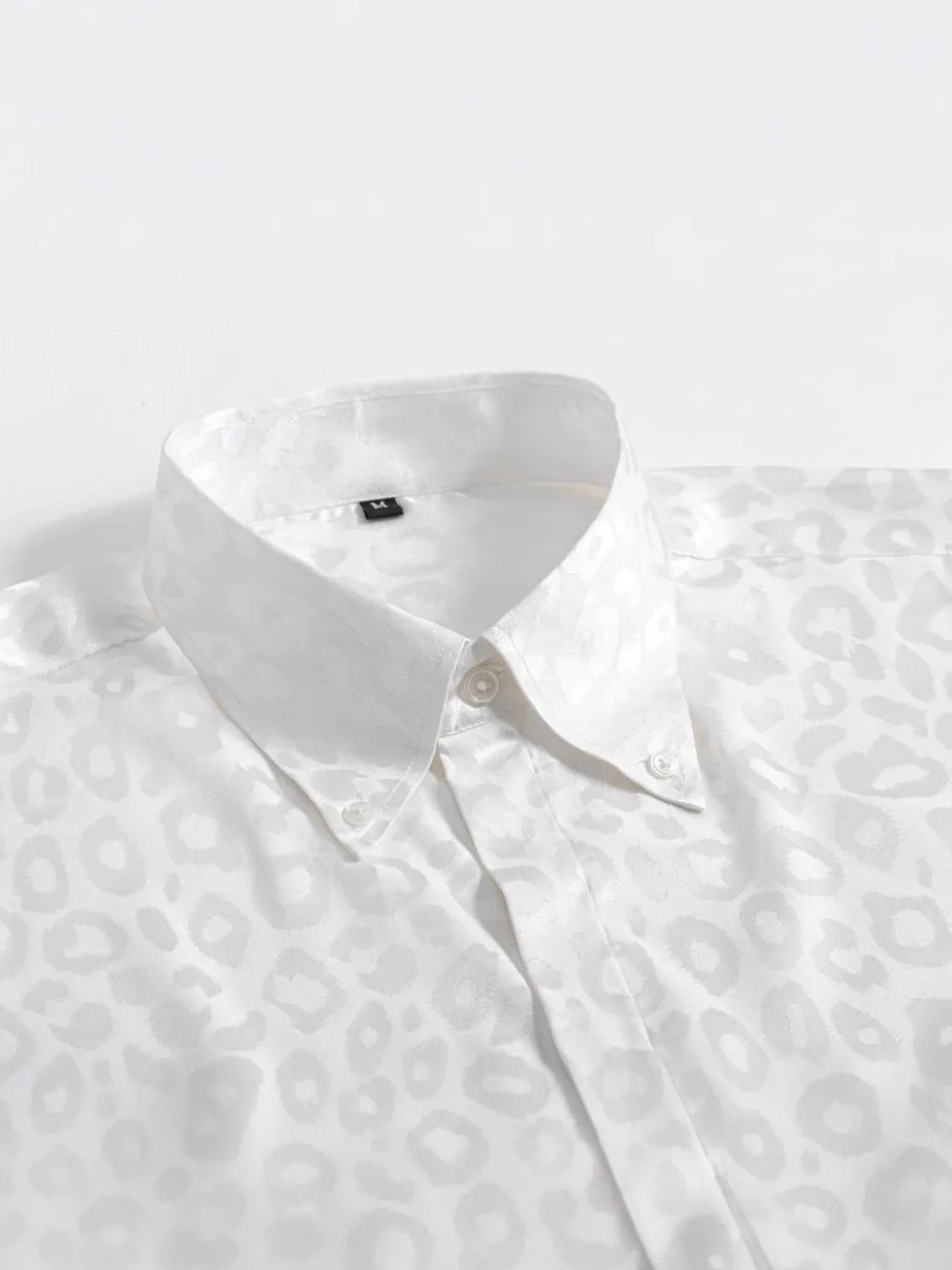 White Leopard pattern Button Down Satin Shirt  on a light gray background close up