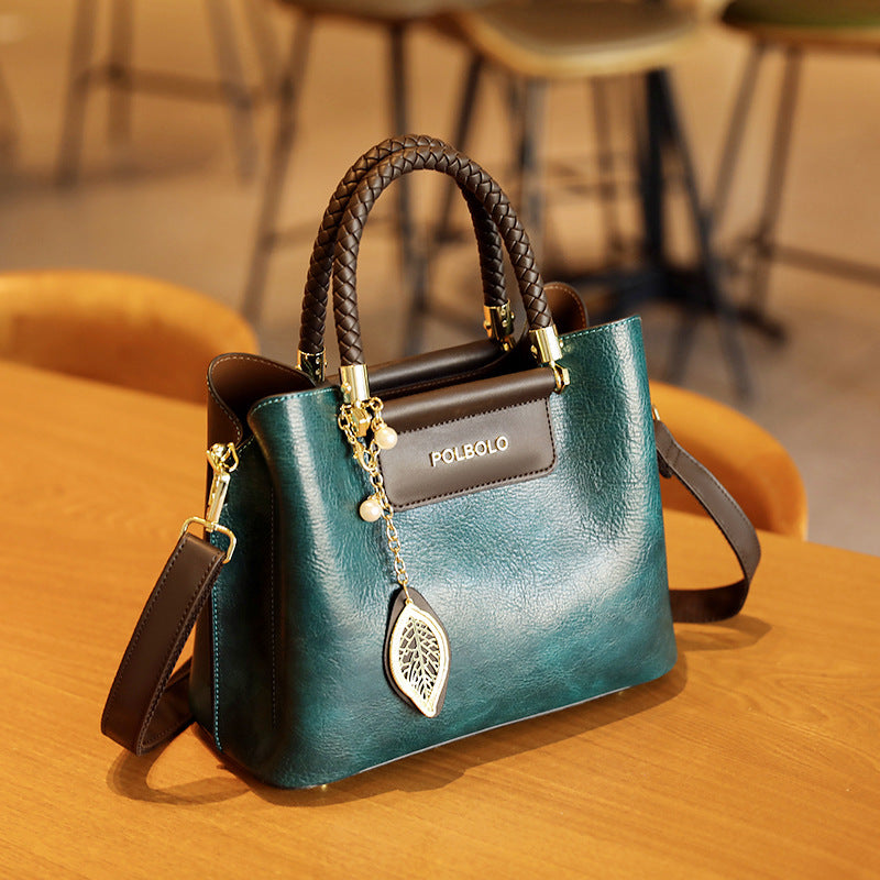Blue handbag with braided handle on a wooden table