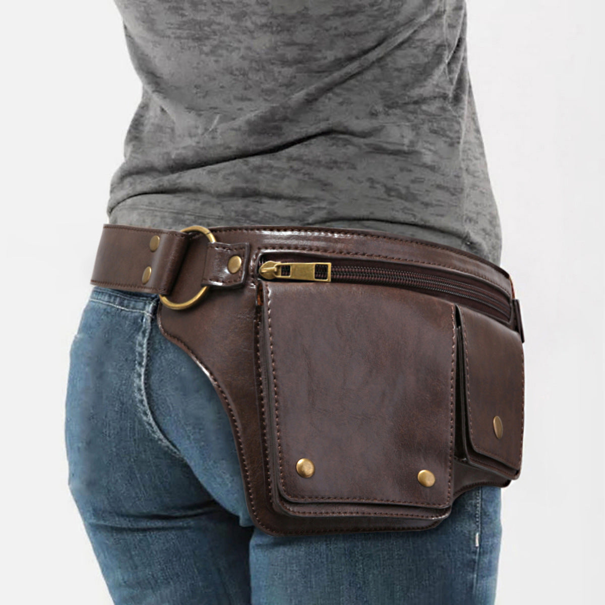 Brown leather waist bag worn by a person on a white background
