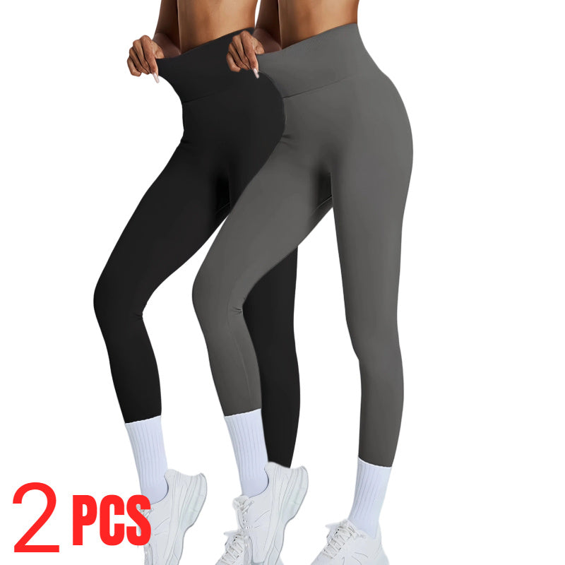 Two pairs of leggings, one black and one gray, worn by a person on a white background.