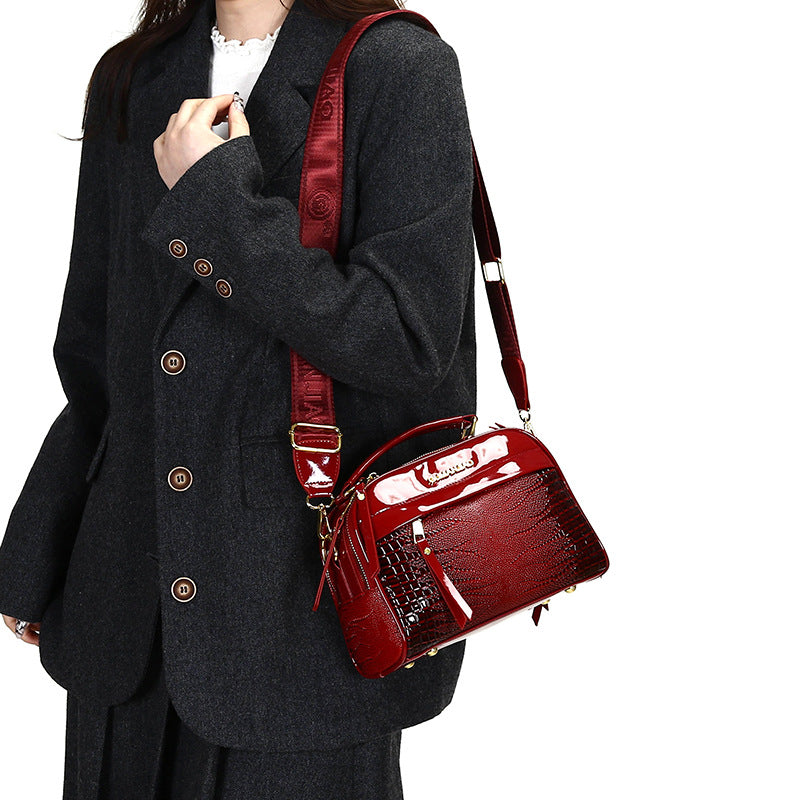 Person wearing a dark coat with a red handbag on a white background