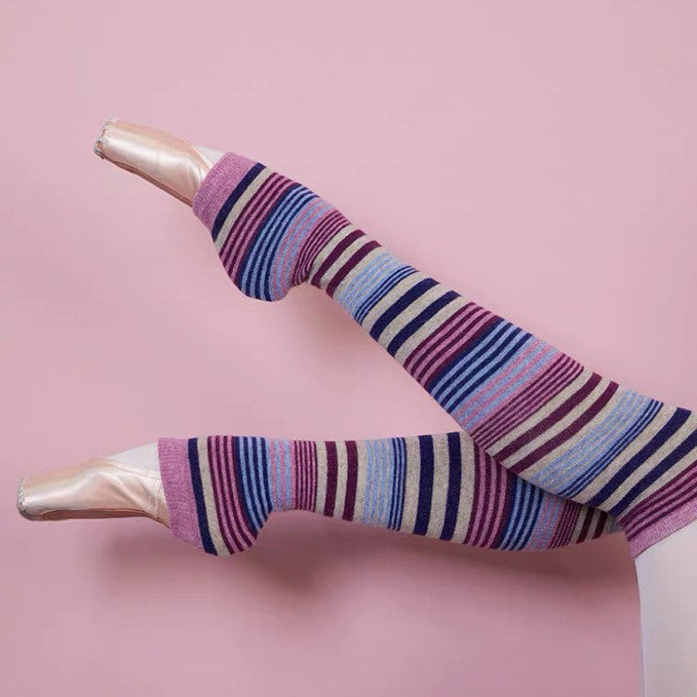 Striped tights worn by a person on a pink background