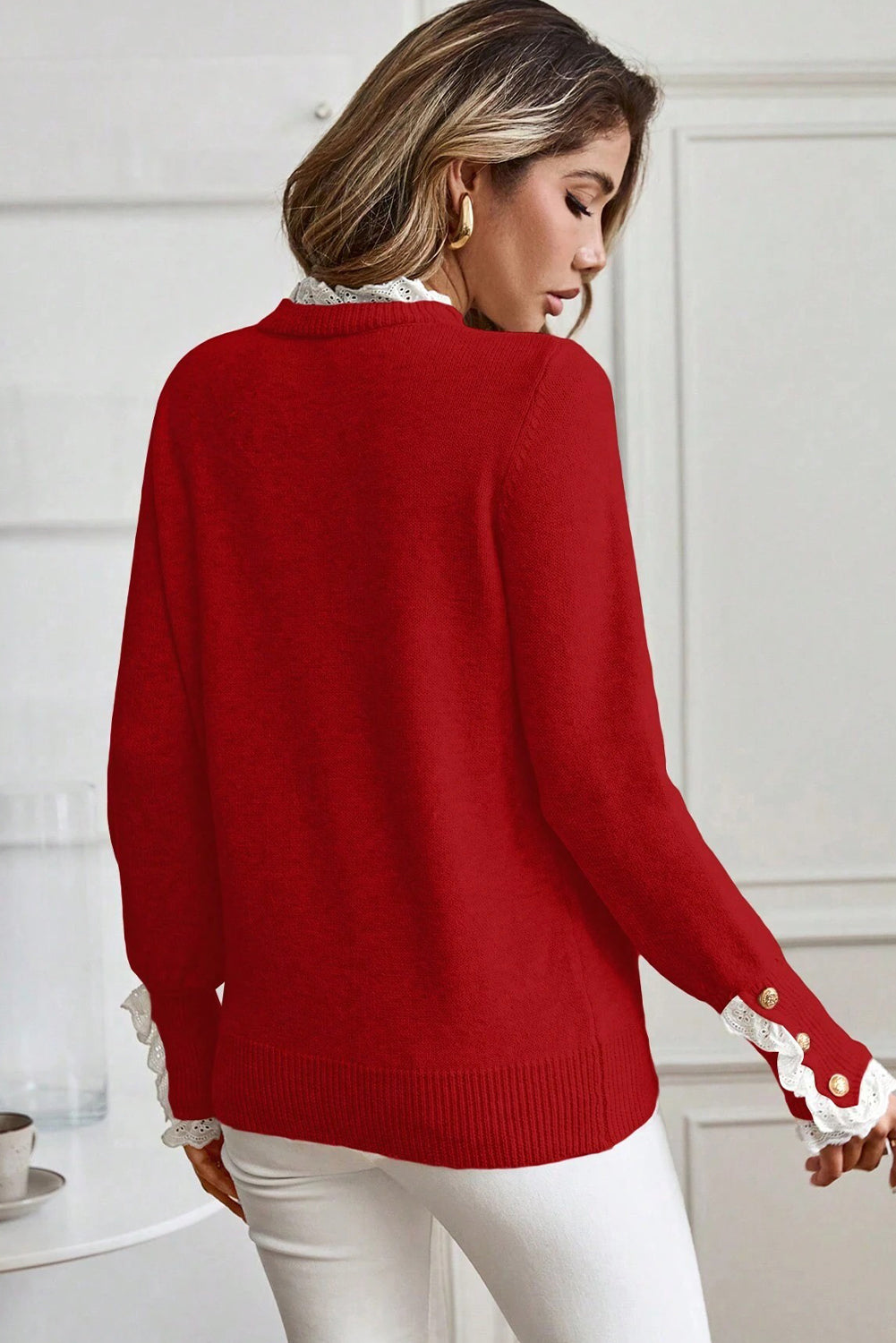 Model wearing a red Women's Lace Trim Buttoned Cuff Sweater with white lace trim back view