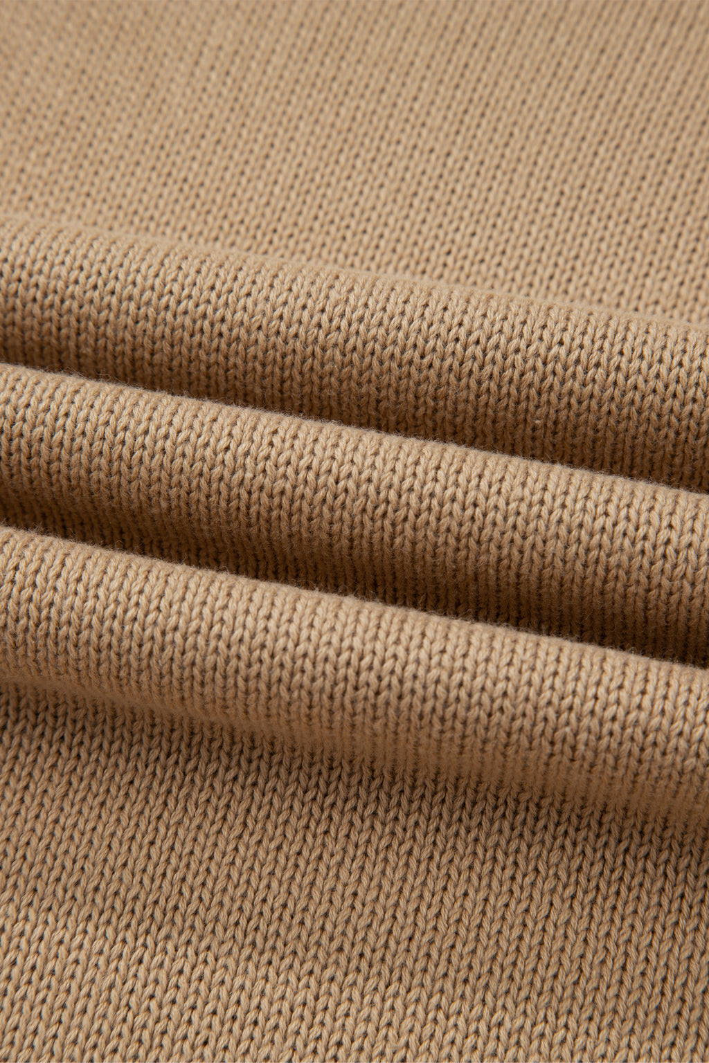 Close-up of a Women's Khaki Exposed Seam Mini Sweater Dress textured pattern