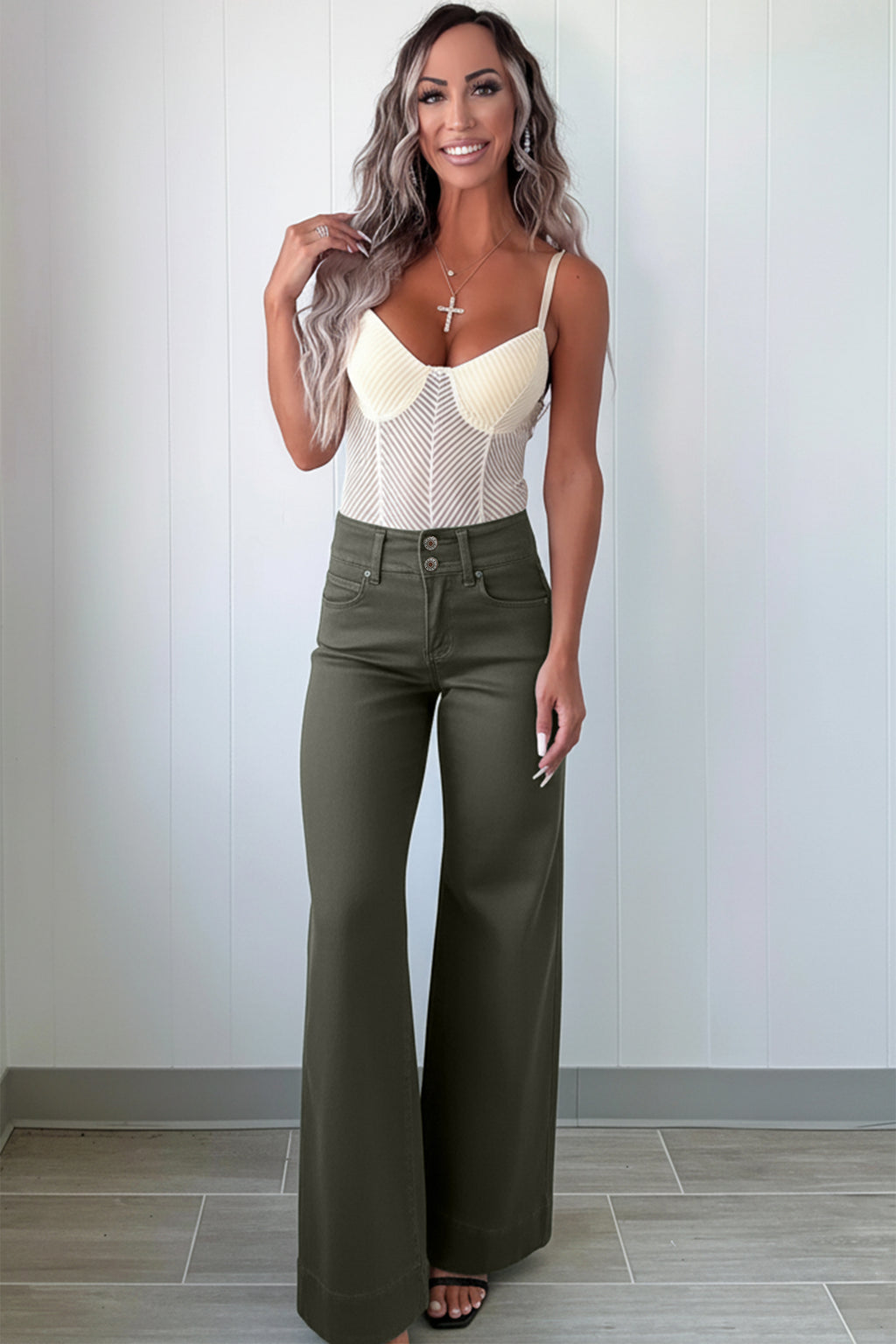 A woman modeling a cream-colored crochet knit camisole top paired with olive green  High Waist Wide Leg Jeans
