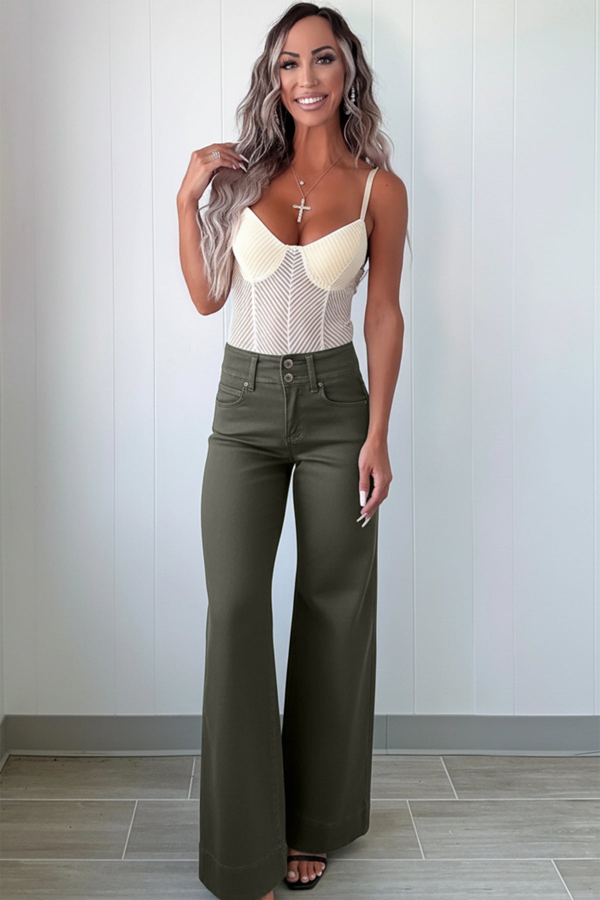 A woman modeling a cream-colored crochet knit camisole top paired with olive green  High Waist Wide Leg Jeans