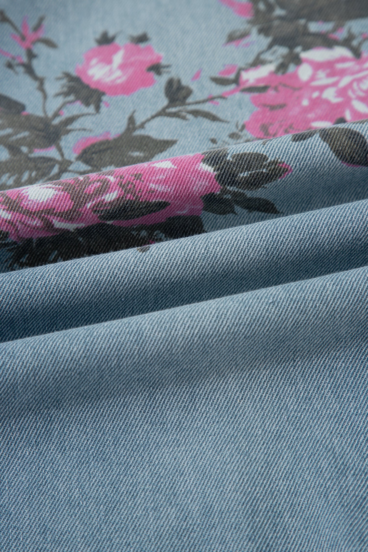 Close-up of blue fabric with pink floral pattern