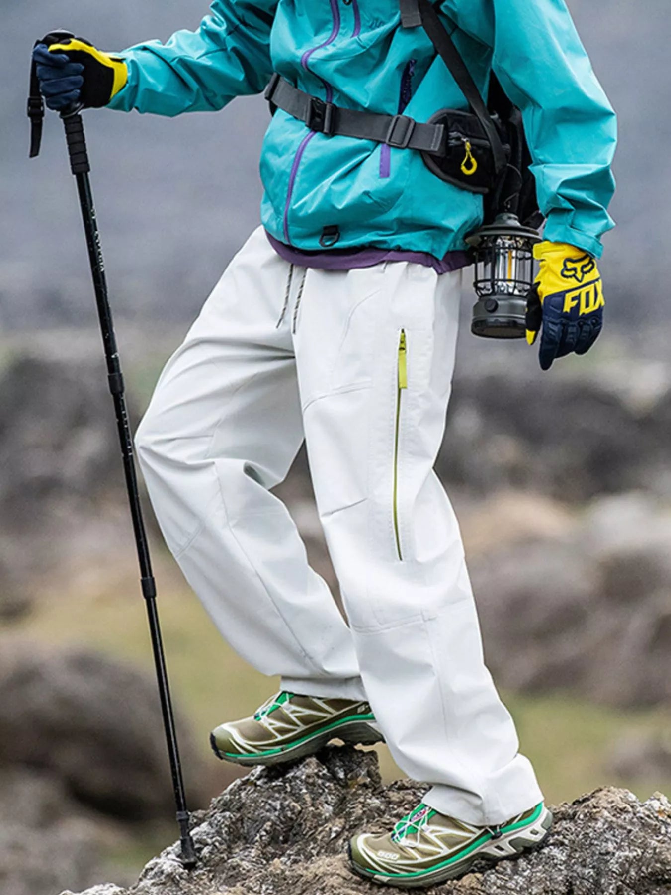 Model wearing White colored Men's Trailblazers (Hiking) Drawstring Wide Leg Pants on a mountain 