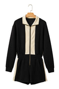 Black and beige jumpsuit on a hanger against a white background