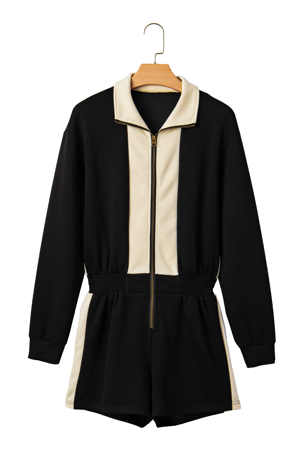 Black and beige jumpsuit on a hanger against a white background