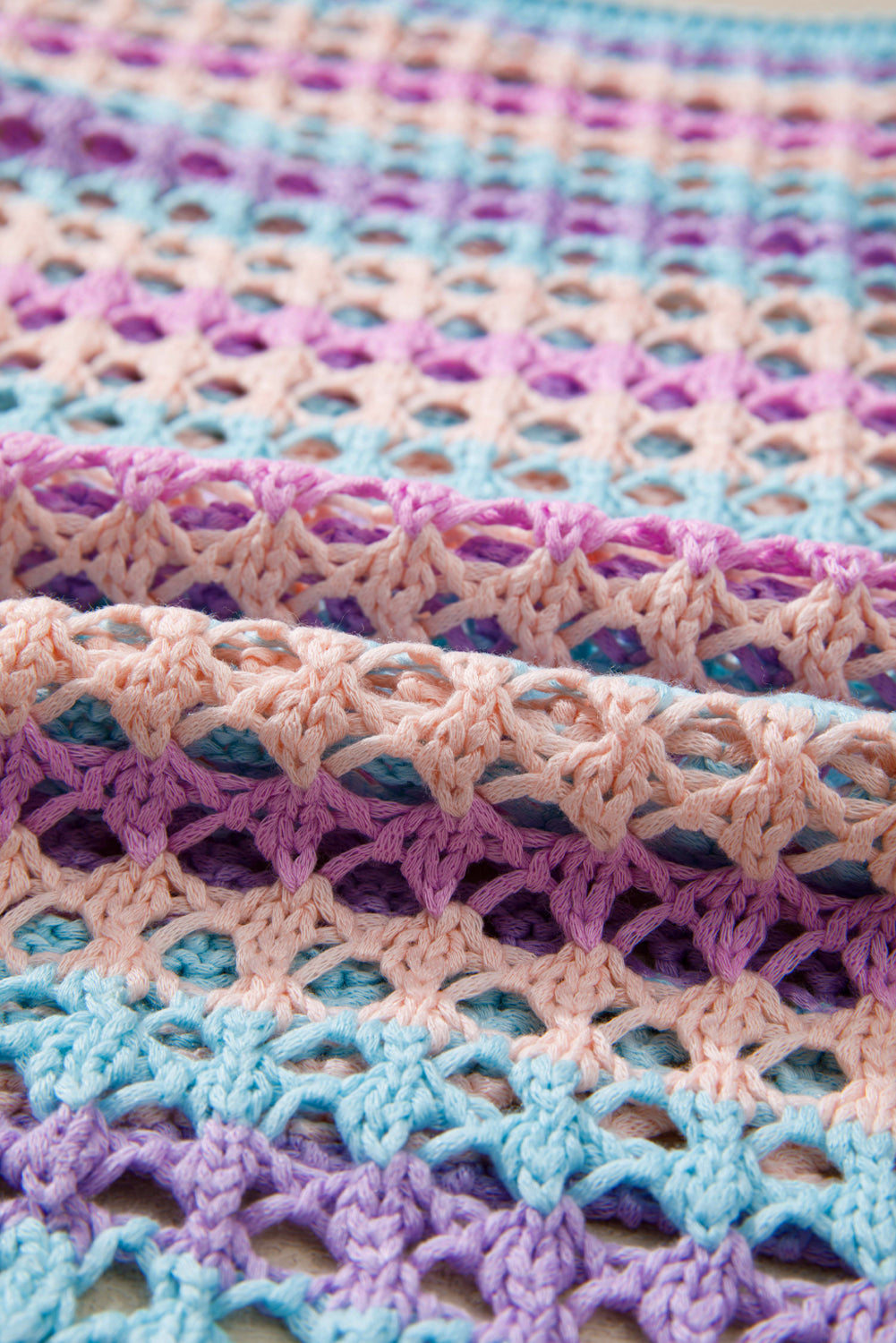Close-up of a crocheted blanket with pastel colors