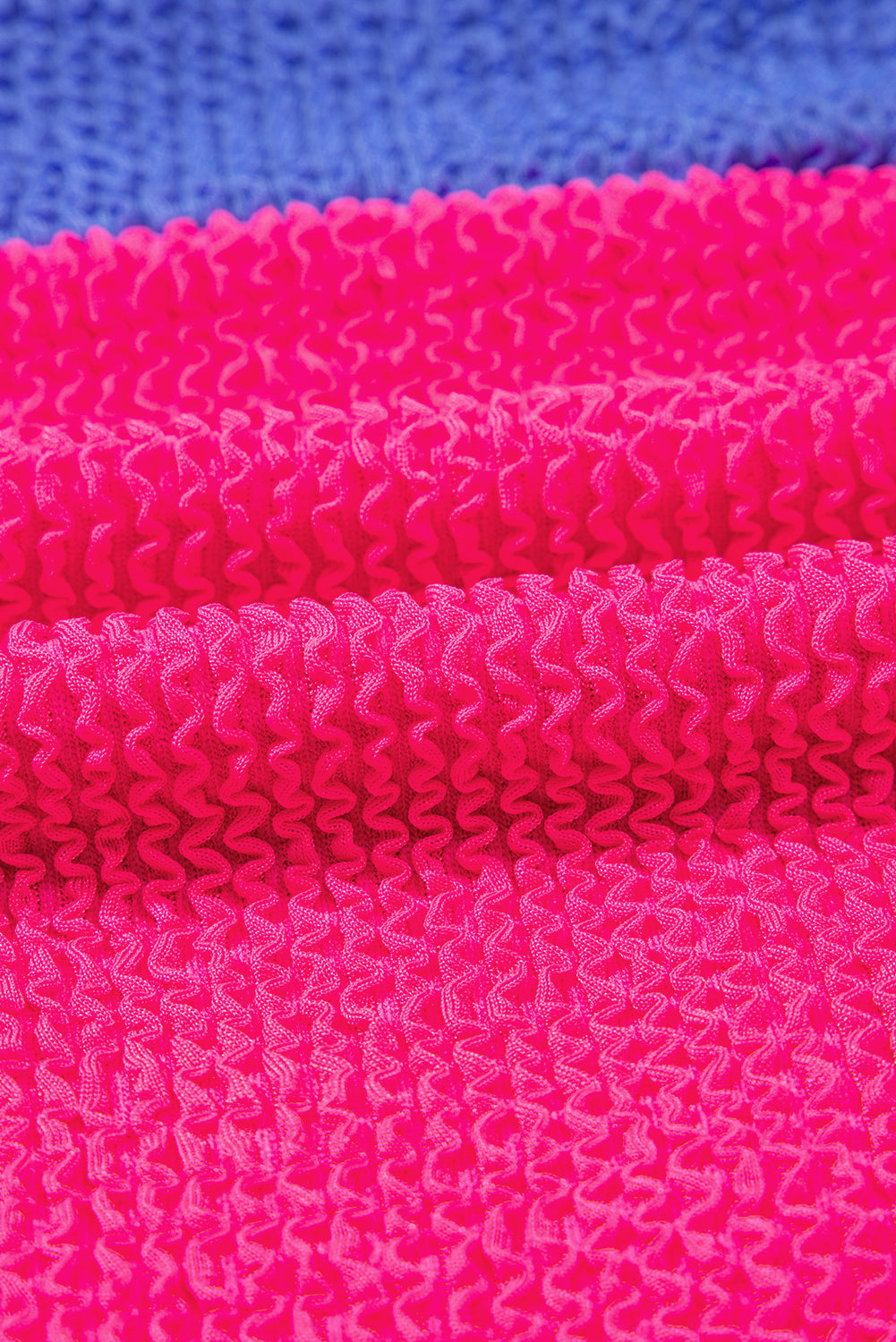 Close-up of pink textured fabric with a blue background
