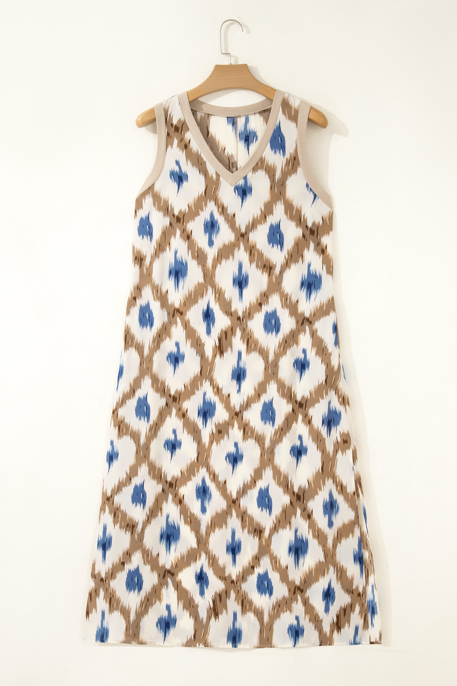 Dress with blue and brown pattern on a hanger against a white background front