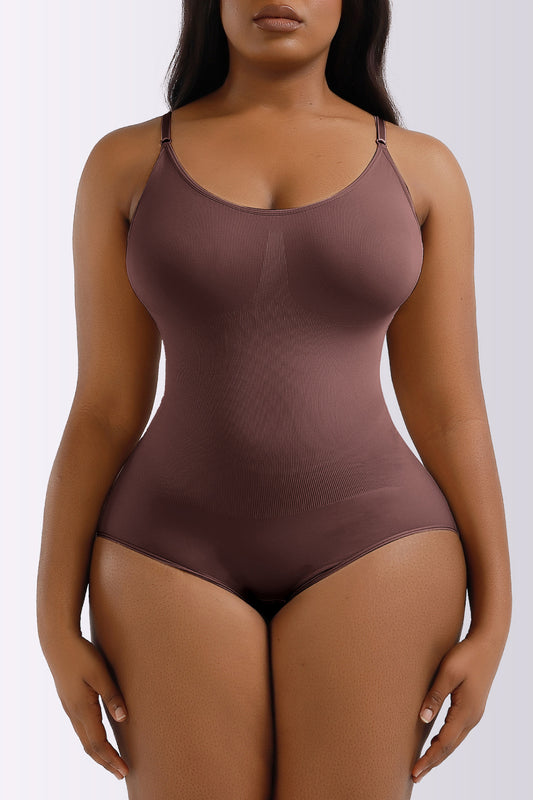 Brown bodysuit worn by a model on a white background