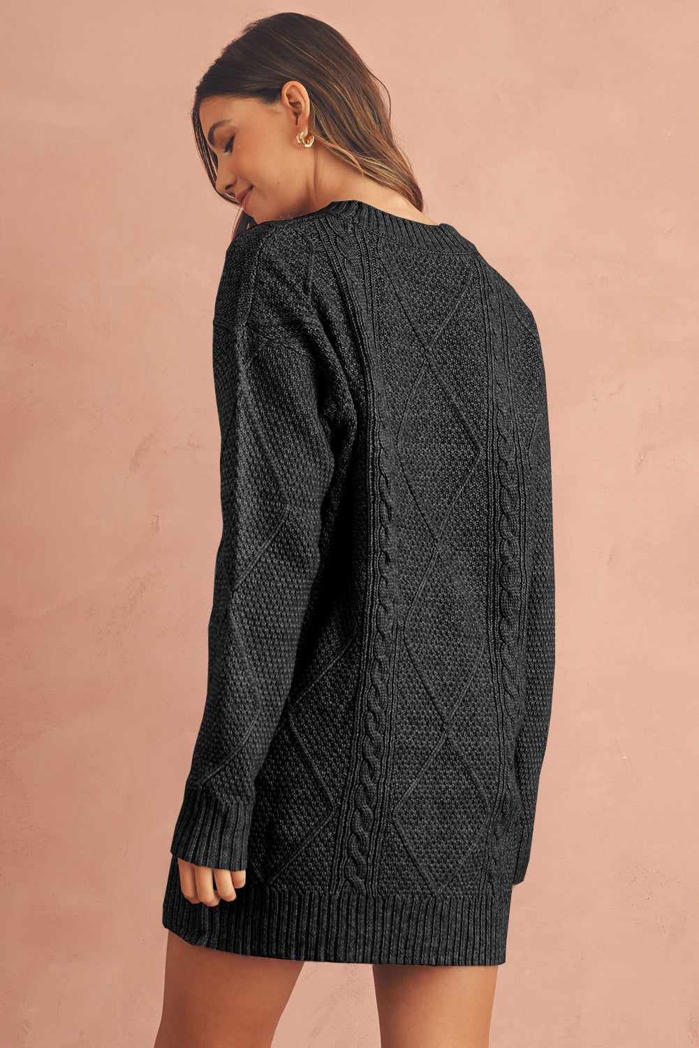 Woman wearing a dark gray cable knit sweater dress back view