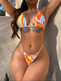 Person wearing a colorful bikini standing against a concrete wall.
