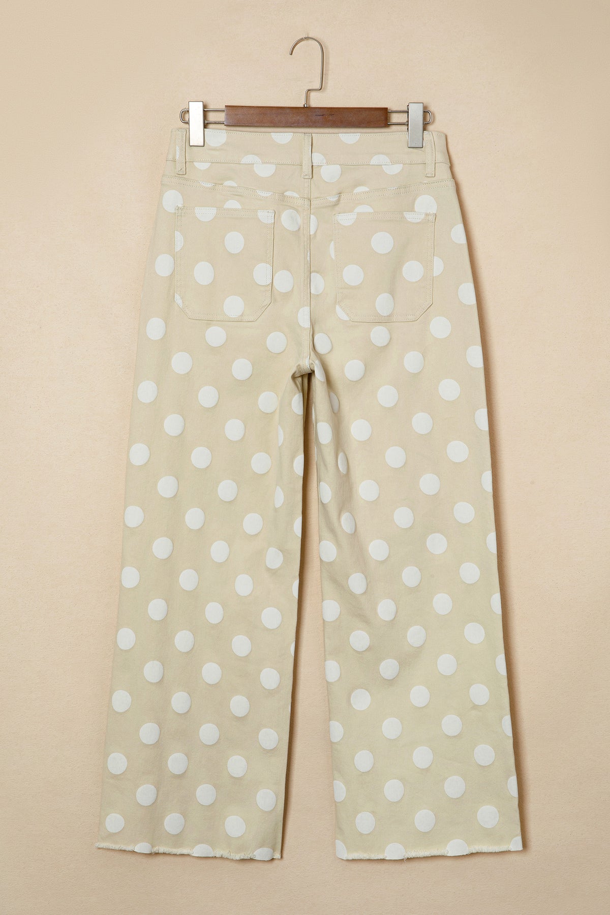 Polka dot pants back view on a beige background  