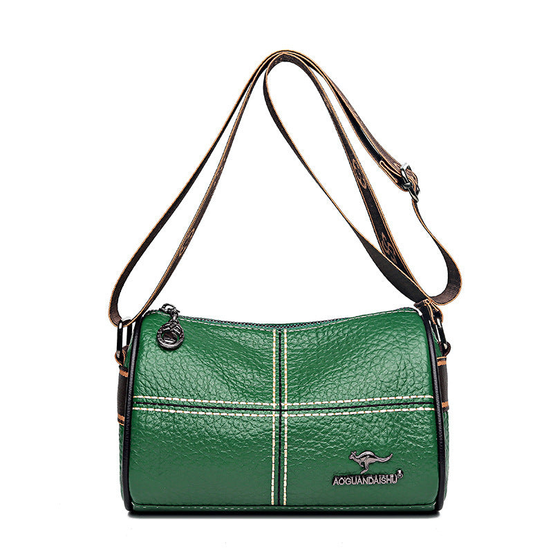 Green handbag with a visible brand logo on a white background