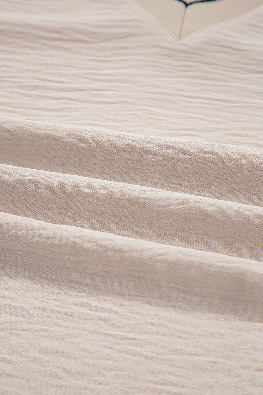 Close-up of beige fabric with subtle texture