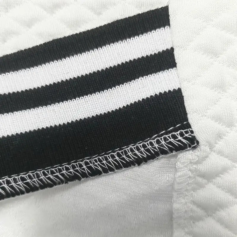 Close-up of black and white striped fabric with a textured background