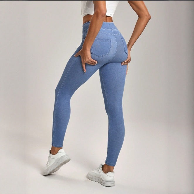 Person wearing blue jeans on a plain background