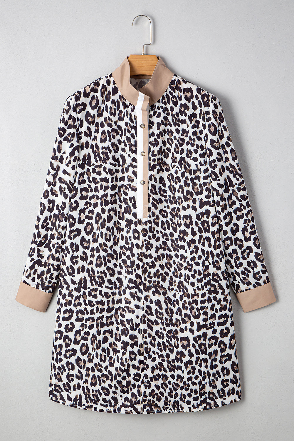 Front view of a leopard print dress displayed on a hanger, highlighting the sophisticated collar and playful print