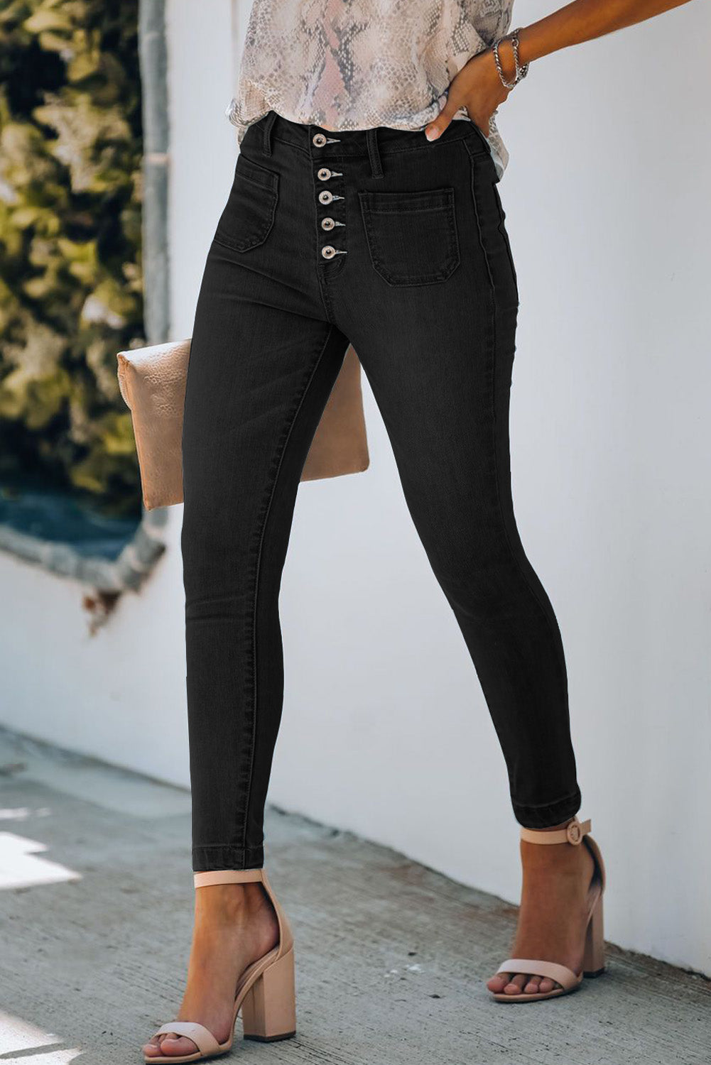 A model wearing a pair of Black Women's Chic Button Fly Skinny Jeans