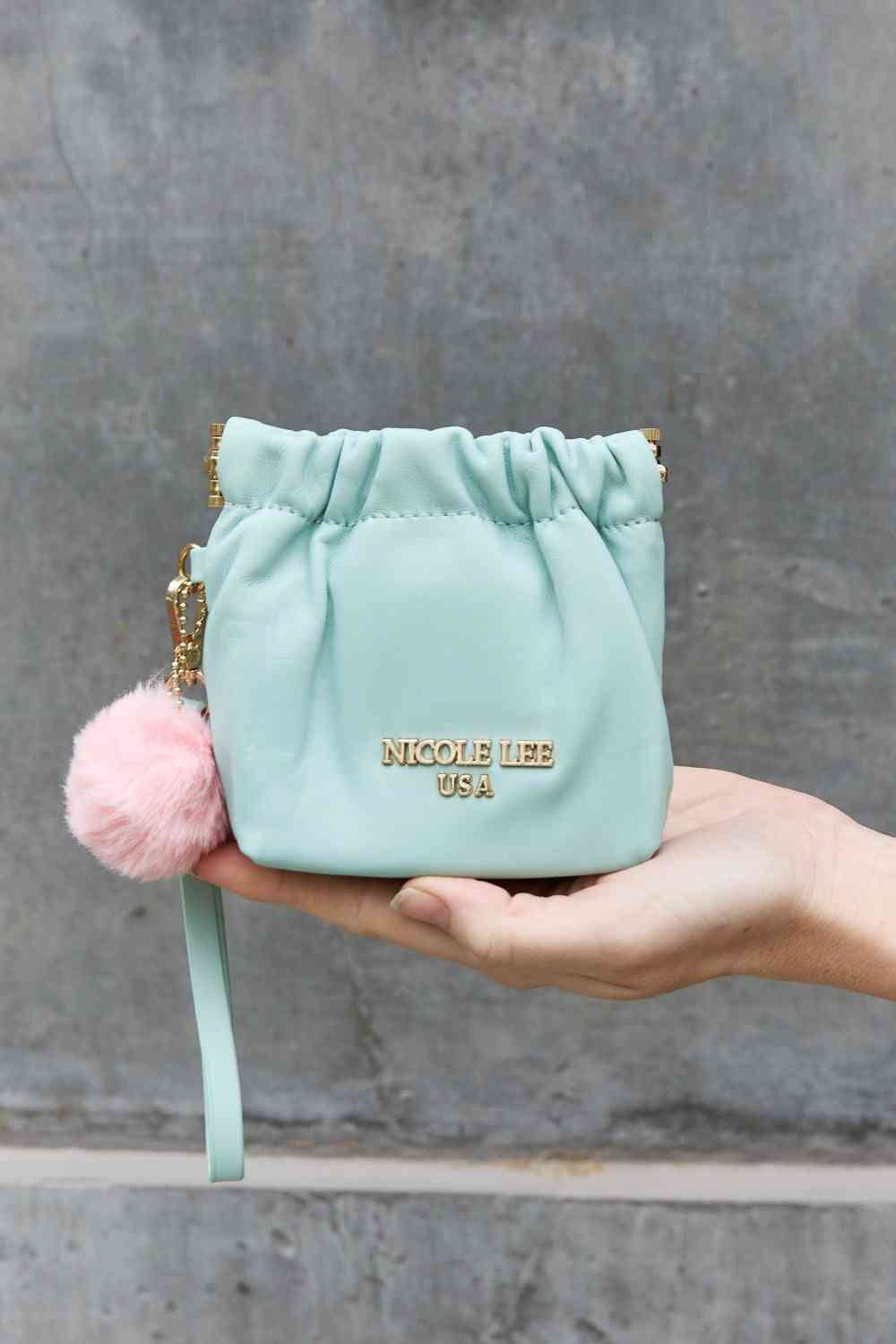 Model holding Mint Ladies Luxurious Chic Faux Leather Pouch