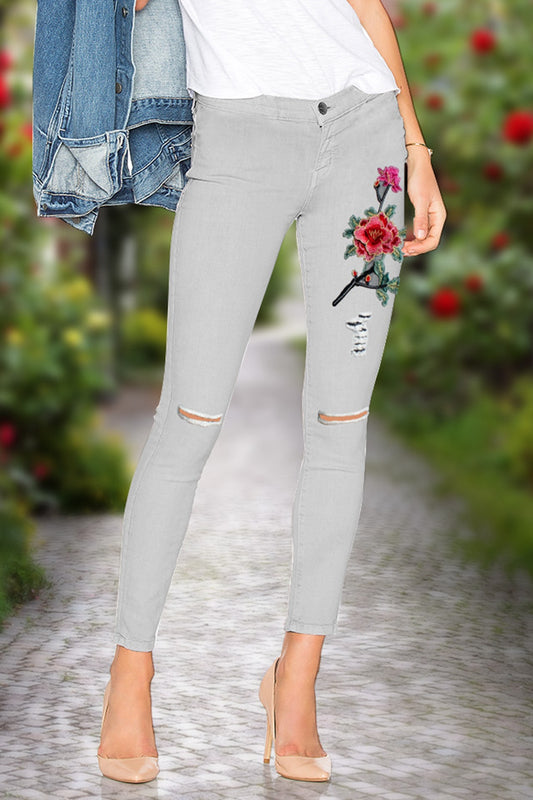These stylish Flower Embroidery Cutout Jeans are perfect for the modern woman. Featuring a decorative knee cutout with intricate embroidery designs, 